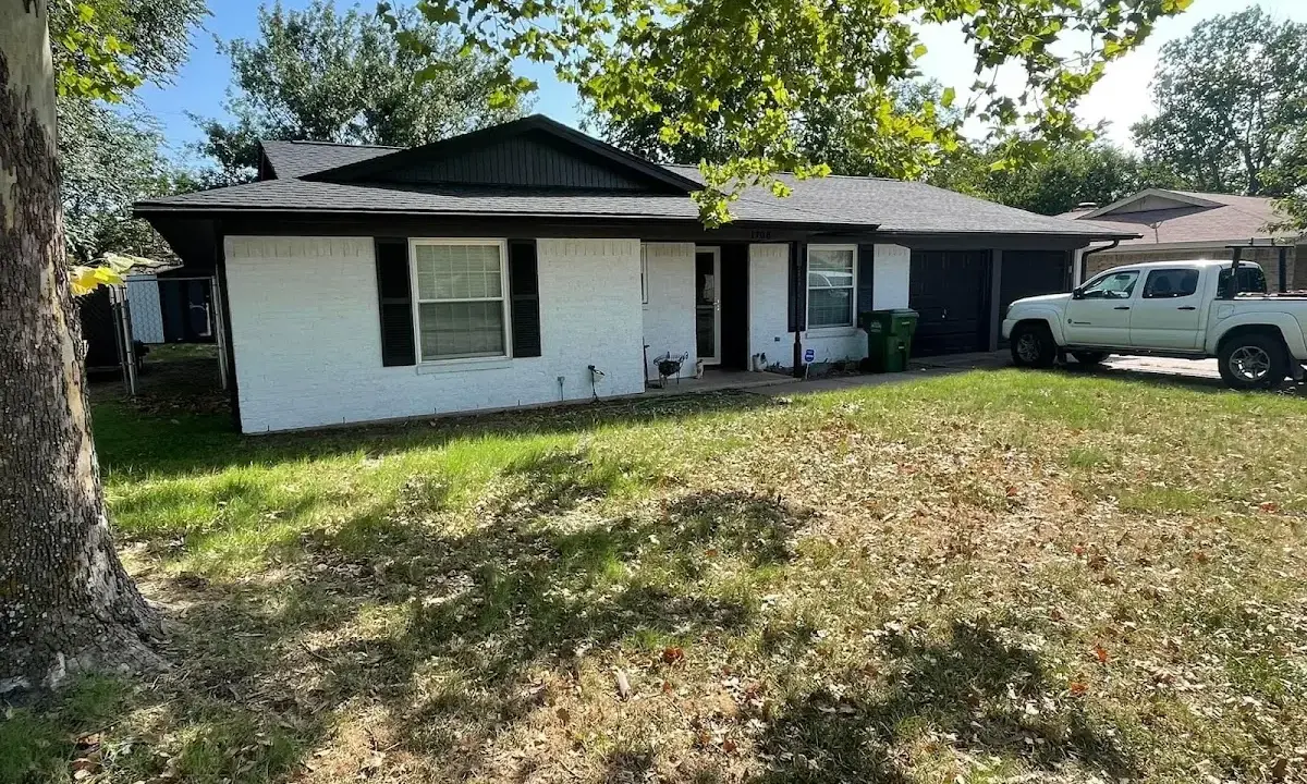 Professional roofing crew working on a residential roof in Jersey Village